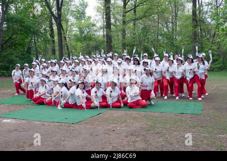 Frauen aus Wenzhou, China, feiern in der Kai Xin Yizhu Tanzgruppe den Muttertag, indem sie für ein Gruppenfoto posieren und Rosen halten. In einem Park in NYC. Stockfoto