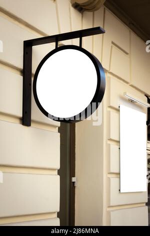 Modell. Leere weiße runde Beschilderung und vertikale rechteckige Schild an der Wand des klassischen Architekturgebäudes in der Stadt Stockfoto