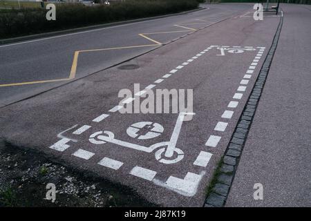 Dedizierter Elektroroller Parkplatz Schild Spray auf Stadt Bürgersteig gemalt. Parkplatz für Elektroroller Stockfoto