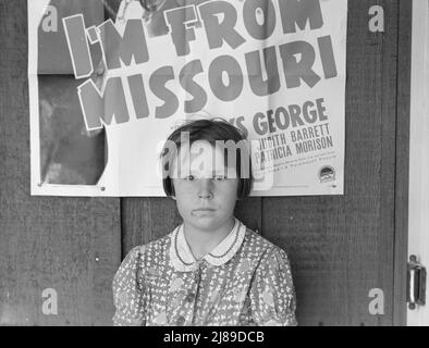 Werbung für aktuellen Film in der Stadt. Das Kind ist ein Flutflüchtling vom 1938. März aus dem Südosten von Missouri. Westley, Kalifornien. Stockfoto