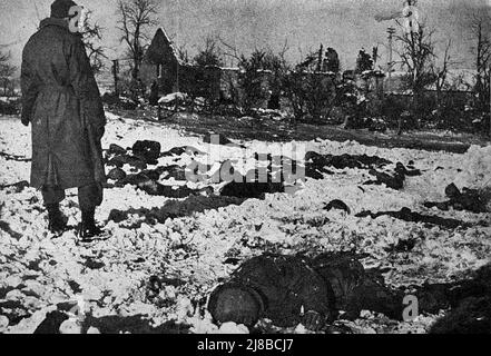 Jemand, der sich die Leichen hingeführter amerikanischer Soldaten ansieht, bekannt als das Malmedy-Massaker während der Bulge-Schlacht im Zweiten Weltkrieg Stockfoto