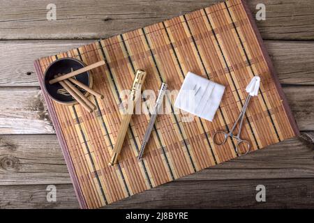 Alternativer Therapeut, der Moxibustion als traditionelle chinesische Medizin anwendet. Arzt, der junge Patienten mit traditioneller asiatischer Medizin heilt. Moxa Stockfoto