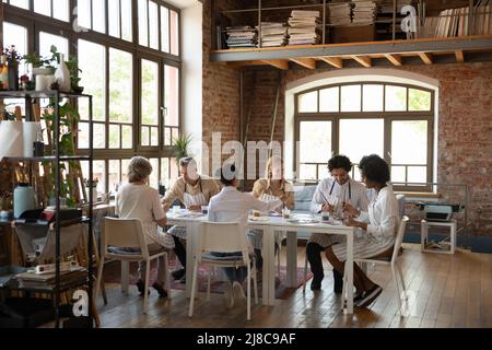 In Loft-Werkstatt Gruppe von sechs multi-ethnischen Künstlern malen Bilder Stockfoto