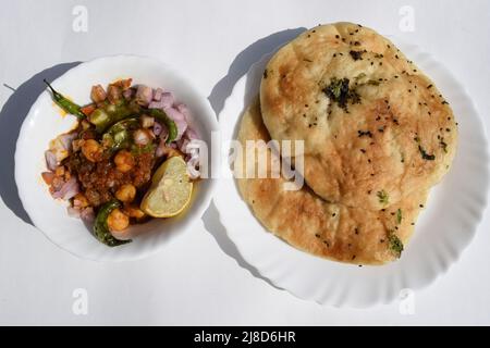 Leckeres nordindisches chhole Kulche-Gericht im punjabi-Delhi-Stil. Chole aus Kichererbsen Chana und Kulcha ist weiches indisches Fladenbrot. Chhole Kulcha Tradition Stockfoto