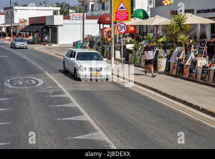 Ayia Napa, Zypern - 31. Mai 2021: Weißer Mercedes 6-türige Taxiwagen auf der Nissi Ave in der Innenstadt. Ayia Napa ist ein Touristenresort am östlichen Ende der Stockfoto
