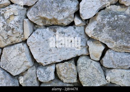 Hintergrund der Kalksteinwand mit felsiger Struktur Stockfoto
