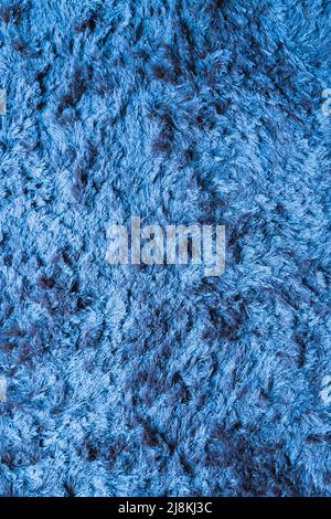 Blauer Stoffteppich mit langem Florstruktur Hintergrund Stockfoto