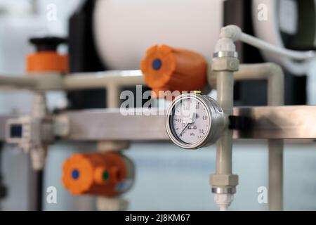 Analoges Manometer und Kunststoffrohrsystem. Selektiver Fokus. Stockfoto