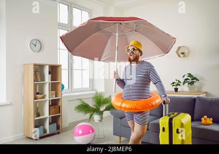 Lustiger, molliger junger Mann, der während der Covid-Pandemie seinen Sommerurlaub zu Hause verbringt Stockfoto