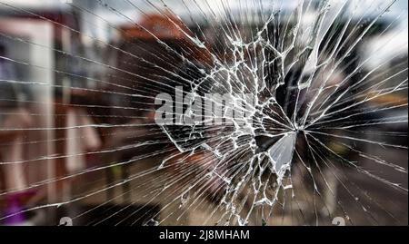 Risse im Glas eines Schaufensters, das durch Artilleriebrüche zerschlagen wurde Stockfoto