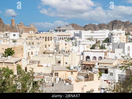 Die Hauptstadt und bevölkerungsreichste Stadt im Oman, Muscat, zeigt erstaunliche Orte, an denen seine weißen Gebäude von beeindruckenden Bergen umgeben sind Stockfoto