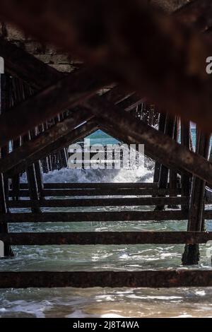 Alte, verlassene Anlegestelle, die über dem Meer verrottet Stockfoto