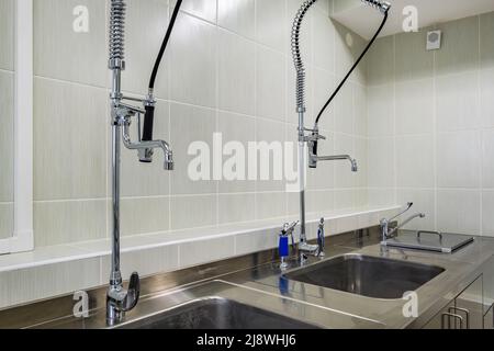 Ellenbogen Seife und antiseptischen Spender oder Desinfektionsmittel Wand zur Händedesinfektion und Wasserhahn Waschbecken mit Wasserhahn Bad oder Klinik montiert Stockfoto