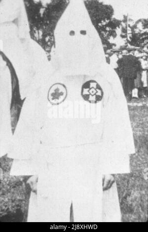 Bild eines Mannes in einer Kapuze und Robe - Ende 1926 betraten die Organisatoren von Klan Saskatchewan. - Nahaufnahme des kanadischen Klansman in voller Regalia, Kingston, Ontario, 1. Juli 1927. Beachten Sie das Ahornblatt-Symbol auf der linken Seite der Brust des Klansman Stockfoto