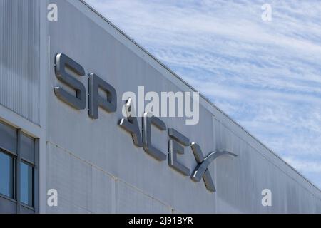 Nahaufnahme des SpaceX-Logos am Hauptsitz in Hawthorne, Kalifornien, vor einem dramatischen Himmel, gesehen am 10. Mai 2022. Stockfoto