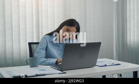 Junge asiatische Frauen sind besorgt oder gestresst über die Arbeit im Unternehmensbüro. Stockfoto