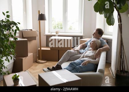Entspanntes reifes verheiratetes Paar in der Liebe, das sich auf der Couch ausruht Stockfoto
