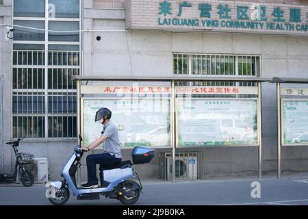 (220522) -- PEKING, 22. Mai 2022 (Xinhua) -- Mei Xiaodong fährt zu einer Gemeinde, nachdem sie die von den Bewohnern des Bezirks Chaoyang in Peking, der Hauptstadt Chinas, bestellten Medikamente gekauft hatte, 21. Mai 2022. Mei Xiaodong, 35, ist Regierungsangestellter des Bezirks Chaoyang in Peking. Mei wurde entsandt, um sich der Arbeit des Frontpersonals in einer Gemeinde im Kampf gegen COVID-19 anzuschließen und den Bewohnern unter Quarantäne zu helfen, Medikamente für chronische Krankheiten zu kaufen. Gemeindemitarbeiter, Ärzte und Freiwillige übernehmen die Verantwortung für die Beurteilung, den Kauf und die Lieferung von Medikamenten, die von Bewohnern über We bestellt wurden Stockfoto