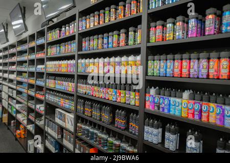 Viele verschiedene Geschmacksrichtungen von E-Liquid-Vapes in einem Vape-Shop. Stockfoto