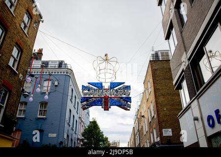 London, Großbritannien. 22.. Mai 2022. Dekorationen zur Feier des Platin-Jubiläums der Königin in der Carnaby Street. Die Dekoration der Union Jack-Flaggen ist im Zentrum von London zu sehen, um das Platin-Jubiläum der Königin vorzubereiten, das den 70.. Jahrestag der Thronbesteigung der Königin markiert. Vom 2.. Bis 5.. Juni findet ein spezielles, erweitertes Platinum Jubilee Weekend statt. Kredit: SOPA Images Limited/Alamy Live Nachrichten Stockfoto