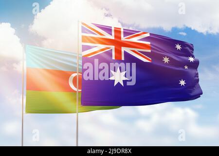 Sonniger blauer Himmel und Flaggen von australien und aserbaidschan Stockfoto