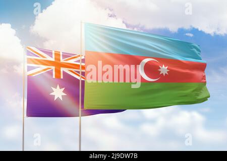 Sonniger blauer Himmel und Flaggen von aserbaidschan und australien Stockfoto