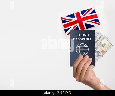 Hand hält einen Pass und britische Flagge einige Dollar Stockfoto