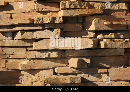 Eine hohe Wand aus Steinen für einen rustikalen Effekt in Schwarz und Weiß. Stockfoto