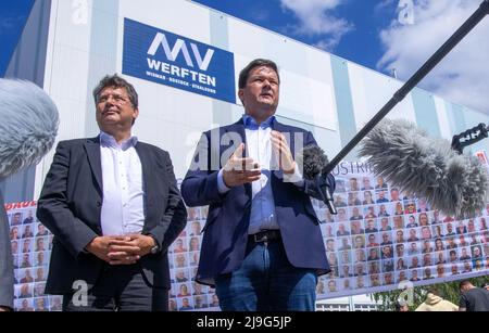23. Mai 2022, Mecklenburg-Vorpommern, Wismar: Reinhard Meyer (l, SPD), Minister für Wirtschaft, Tourismus und Verkehr Mecklenburg-Vorpommerns, und Christoph Morgen, Insolvenzverwalter der Werftgruppe, sprechen nach einem Betriebsgespräch in der MV Werft in Wismar mit Medienvertretern vor der Schiffbauhalle. Die schwedische Reedereigruppe Stena ab ist nicht mehr daran interessiert, den Bau des Kreuzfahrtschiffs „Global One“ fortzusetzen, das zum Insolvenzbesitz der MV Werften Group gehört. Die Fortführung des Transferunternehmens und die Rettung der 1.500 Arbeitsplätze dürfen nicht Stockfoto