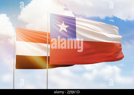 Sonniger blauer Himmel und Flaggen von chile und jemen Stockfoto