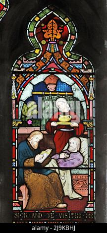 Ein Buntglasfenster von Frederick Preedy, das Corporal Acts of Mercy, St Peter and St Paul's Church, King's Sutton, Northamptonshire, zeigt Stockfoto