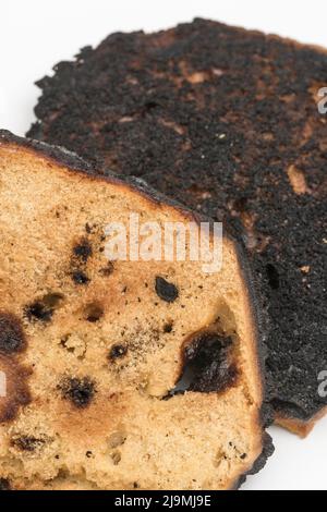 Brot, das auf einer Seite verkocht und zu einer Zünette verbrannt wurde. Bei Acrylamid und Krebs, Lebensmittel ungenügend zum Essen, schlechte Küchenkenntnisse, nicht in der Lage zu kochen. Stockfoto