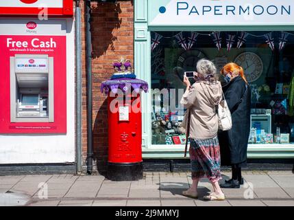 Mystery Knitter enthüllt den Platinum Jubilee Crown Postbox Topper in Syston, Leicester, Großbritannien. Dies ist die jüngste Kreation des Strickkünstlers, der als Syston Knitting Banxy bekannt ist. Stockfoto