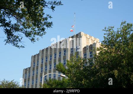 (220525) -- HOUSTON, 25. Mai 2022 (Xinhua) -- das Foto vom 24. Mai 2022 zeigt die Flaggen der Hälfte des Personals auf dem Gebäude des Texas Department of Transportation in Austin, Texas, USA. Mindestens 19 Kinder und zwei Erwachsene wurden am Dienstag bei einer Schießerei an der Robb Elementary School in der Stadt Uvalde, Texas, getötet. (Fotos von Bo Lee/Xinhua) Stockfoto