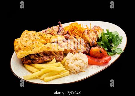 Saftiges Tawuk-Seil aus Hähnchenflügeln mit Reis und Pommes auf schwarzem, isolierten Hintergrund Stockfoto