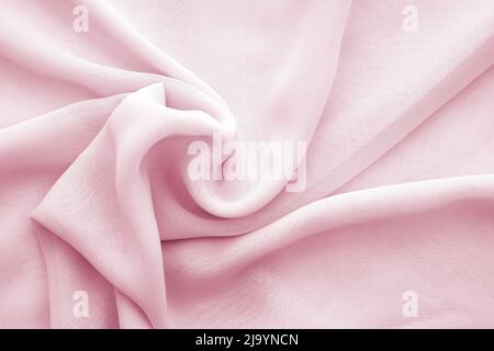 Gewellte rosa Chiffon Textur oder Hintergrund, verdreht weichen transparenten Chiffon Stockfoto