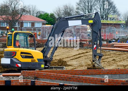 Bagger arbeitet an der neuen Wohnbaustelle Stockfoto