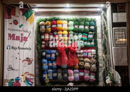 Bild eines Schaufensters eines Ladens, der Garn und Wollbals in verschiedenen Farben und Größen verkauft, für das Handwerk. Stockfoto