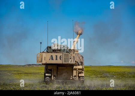 Die 1. der 148. Field Artillery Regiment der Idaho Army National Guard führten während ihrer jährlichen Ausbildung im Orchard Combat Training Center vom 12. Bis 27. Mai 2022 Live-Feuertraining mit dem M109A6 Paladin und über 80 hochexplosiven Runden durch. Das Training beinhaltete die erste Live-Feuerübung mit dem modernisierten M1156 Precision-Leitsatz der US-Armee, einem intelligenten GPS-Fuze-Aufsatz, der es dem Bataillon ermöglichte, seine vorhandenen 155mm Artilleriesullen in intelligente Waffen umzuwandeln und die Zielbahn zu verbessern. (USA Foto der Nationalgarde von Meister Sgt. Becky Vanshur) Stockfoto