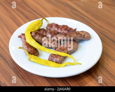 Gegrillte Fleischbällchen auf einem weißen Teller Stockfoto