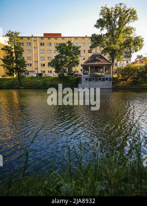 Breslau, Polen - 2021. Juni: Großer Block aus Wohnung und kleinem Café über dem kleinen Stadtgraben an sonnigen Tagen Stockfoto