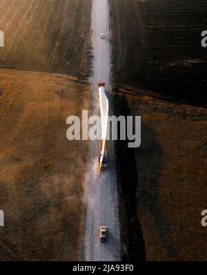 Turbinenschaufeln für eine Windenergieanlage, die per LKW zur Baustelle transportiert wird Stockfoto