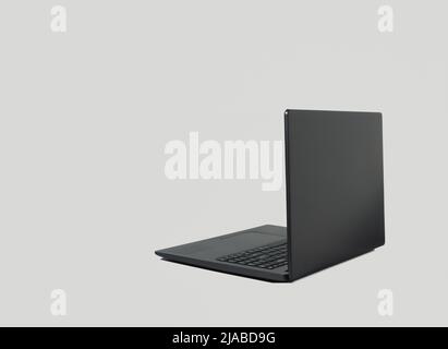 Schwarzer Laptop-Computer mit Schatten auf grauem Hintergrund. Speicherplatz kopieren. Konzept „Arbeiten von zu Hause aus“. Stockfoto