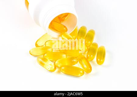 Hellgelbe ovale Pillen mit Fischöl (Omega-3 Vitamin) in der medizinischen Flasche auf weißem Hintergrund. Stockfoto