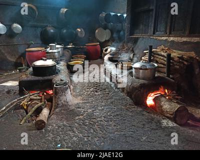 Landküche in Zentral-Java, Indonesien mit einem länglichen Ofen, der für mehrere Töpfe verwendet werden kann, mit Holzstämmen Stockfoto