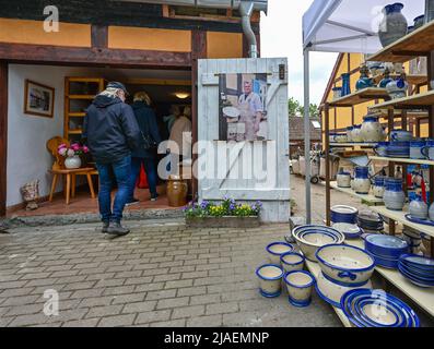 28. Mai 2022, Brandenburg, Groß Neuendorf: Besucher sind auf dem Töpfermarkt zu sehen. Am 27.05.2022 begannen die dreitägigen 24. Art Loose Days im Oderbruch in Ostbrandenburg. Präsentiert werden Gemälde, Keramik, Schmuck und Fotografien von etwa 40 Künstlern, die ihre Ateliers und Höfe für Besucher öffnen. Viele Künstler aus der Region leben auf so genannten losen Bauernhöfen - weit verstreut im Oderbruch. Der Oderbruch entstand nach der Entwässerung vor fast 270 Jahren, wurde vom preußischen König Friedrich II. Mit Kolonisten besiedelt und ist als Lebensraum mit einem genialen Wassersystem erhalten. Foto: Patrick Ple Stockfoto