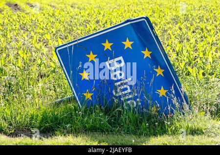 Slenaken, Niederlande, 29. Mai 2022: Straßenschild, das die Grenze zu Belgien anzeigt, in einem landwirtschaftlichen Feld gefallen und beschädigt Stockfoto