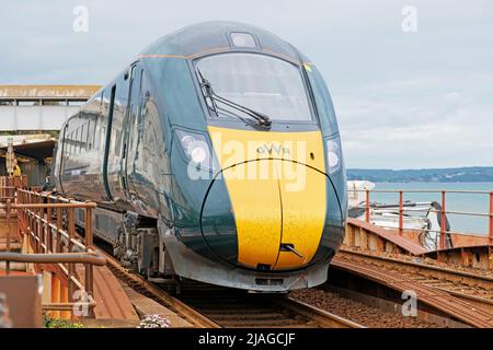 Ein großer westlicher Zug zwischen den Städten, der den Bahnhof der Stadt verlässt Stockfoto