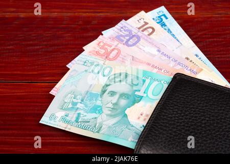 Scottish Money - Pfund in der schwarzen Brieftasche Stockfoto