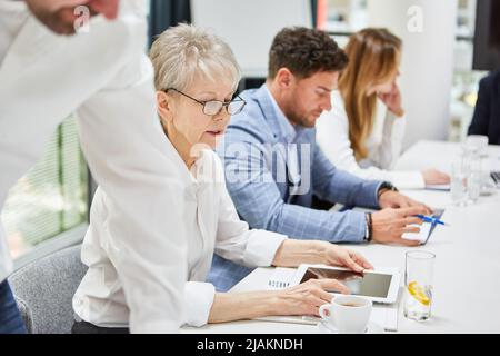 Geschäftsleute, die in einem Meeting oder Strategiemeeting am Konferenztisch sitzen Stockfoto